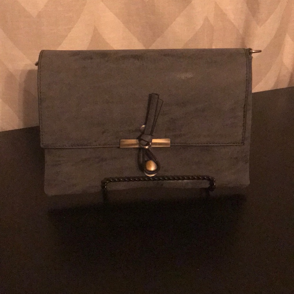Charcoal gray clutch with crossbody strap.